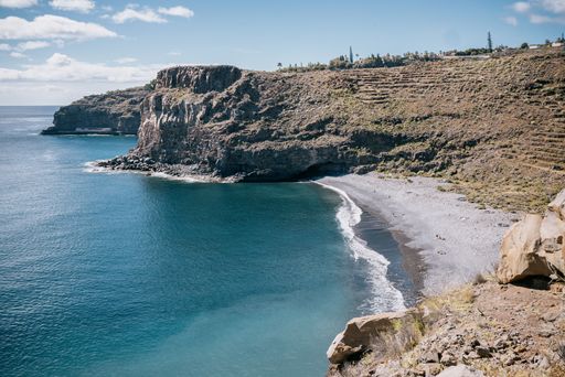 The rocky cliffs overlook over a secluded beach and ocean area, La Gomera, Canary Islands, Spain