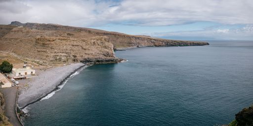 A stunning landscape of rolling hills and rugged coastline with a beautiful blue ocean, La Gomera