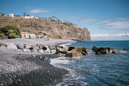 A sandy beach with boulders and cliffs by the ocean shore, La Gomera, Canary Islands, Spain