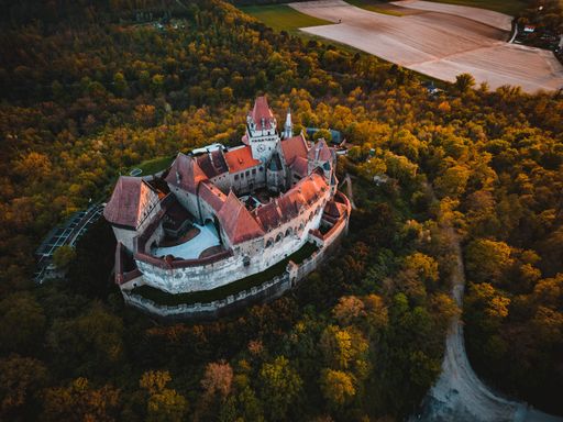 An aerial shot of an ancient Kreuzenstein castle at vibrant sunset - Lower Austria
