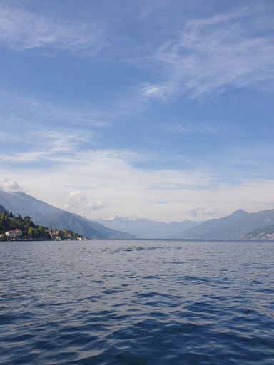 A vertical shot of a beautiful Lake Como under the blue sky  in Italy