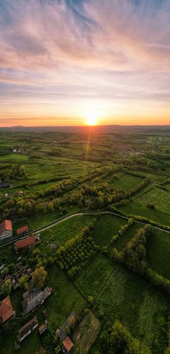 A beautiful sunset over a picturesque countryside landscape