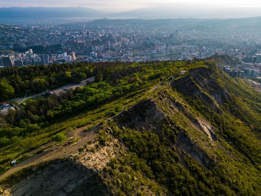 An aerial view of a beautiful mountain with the city of Tbilisi visible in the background. Georgia.