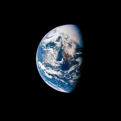 The planet Earth seen from space half-covered in sun light against a black background