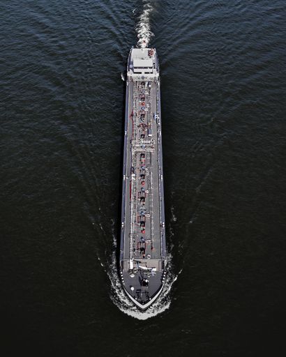 A vertical shot of a ferry sailing in the ocean