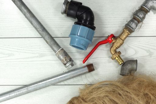 A top view of accessories and hydraulic equipment for gardening on a white surface