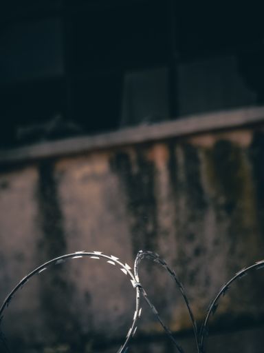 A vertical shot of barbed wires outdoors