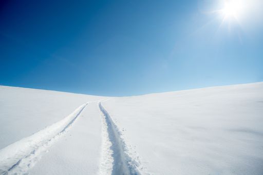 A beautiful view of a snow path on a bright sunny day
