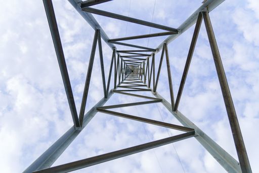 bottom view of a light turret with cloudy sky in the background