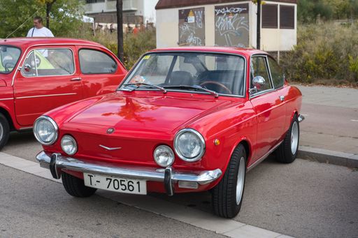 View of the front of a classic Spanish sports car, the Seat 850 Sport Coupe in red color parked in the street