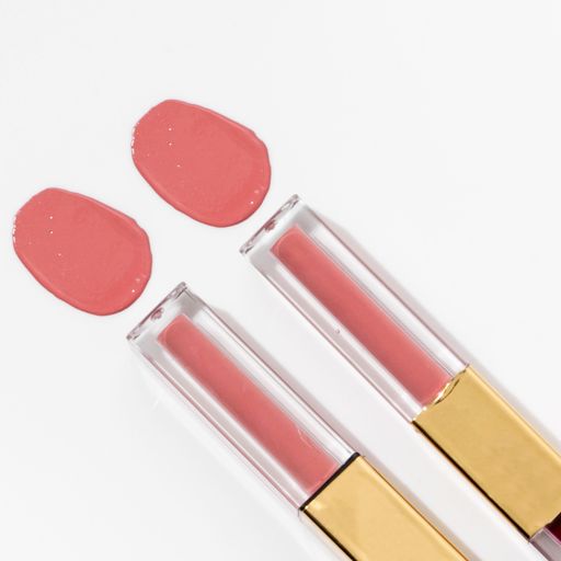 A close-up of a collection of colorful lipstick samples on a white background