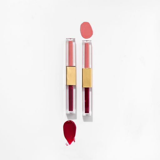 A close-up of a collection of colorful lipstick samples on a white background
