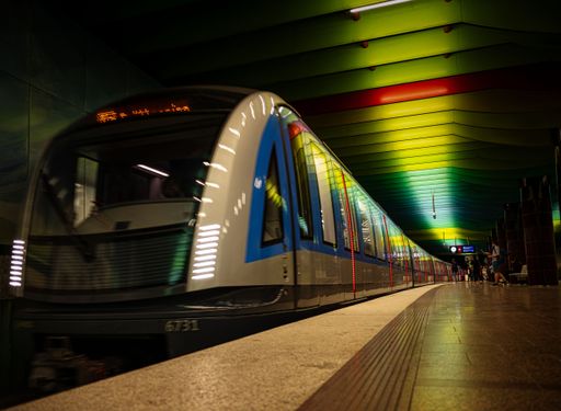 An incoming train in a subway station in Munich, Germany with illumination at the station