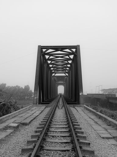 This is a scenic image of a railway bridge that stretches over a river in Bangladesh