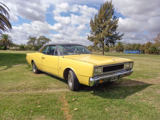 An old yellow 1970s Dodge GTX V8 coupe during CAACMACH 2023 classic car show