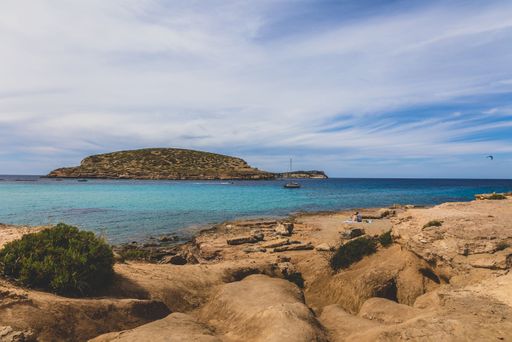 A stunning coastal scene of a boat anchored near a shoreline under the blue sky