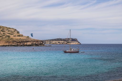 A stunning coastal scene of a boat anchored near a shoreline under the blue sky