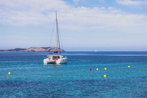 A stunning coastal scene of a boat anchored near a shoreline under the blue sky