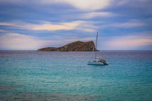 A stunning coastal scene of a boat anchored near a shoreline under the blue sky