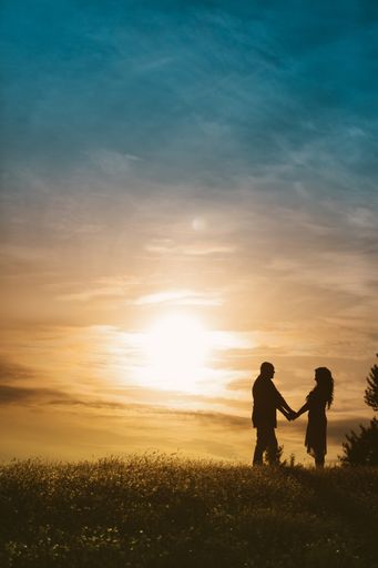 A silhouette of a happy loving couple at sunset