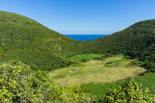 The clear blue sky over the vast green landscape in Furnas do Enxofre, Terceira, Azores, Portugal