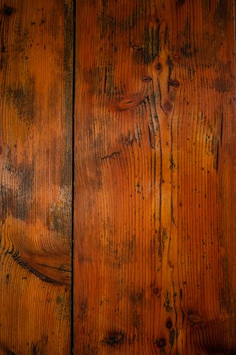 A vertical closeup of a wooden table texture