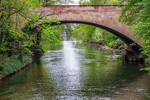 A scenic view of a stone bridge spanning the Pegnitz river near the city of Nuremberg, Germany