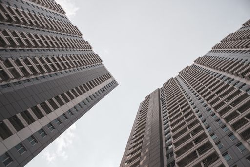 A low angle shot of high-rise apartment buildings against a sky