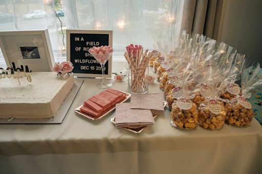 A dessert table with party favors, marshmallow, wafers cookies and sticks, cake and table napkin,
