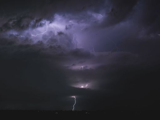 A beautiful shot of striking lightning in a dark purple sky