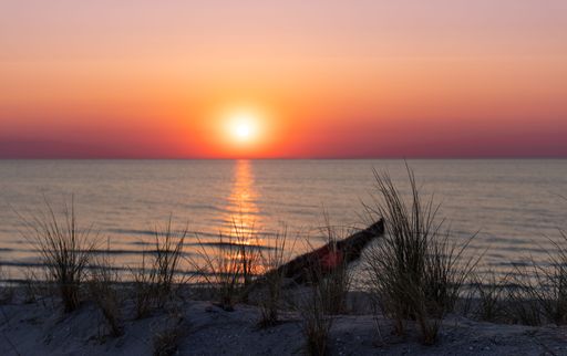 A tranquil scene of a beautiful sunset over the sea at Ahrenshoop beach