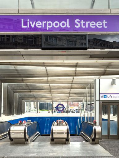 A vertical shot of an escalator in the Underground station of Liverpool Street, leading to the platform below