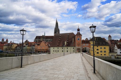 A beautiful view of a pathway on Old Stone Bridge over Danube river in Regensburg, Germany