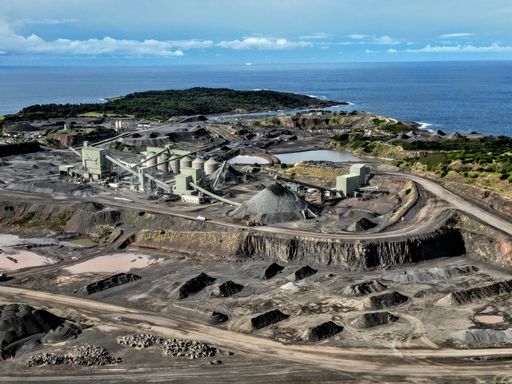An aerial view of a mining site situated on the coastline