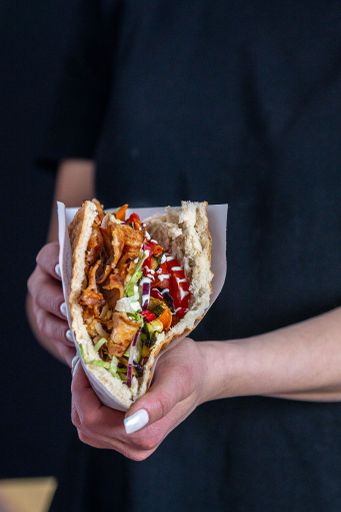 A delicious Berliner doner kebab with fresh turkey and chicken, mixed salad with tomatoes, vegetables and garlic sauce
