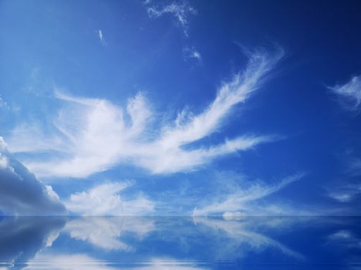 A stunning view of fluffy clouds reflecting on the pure water surface