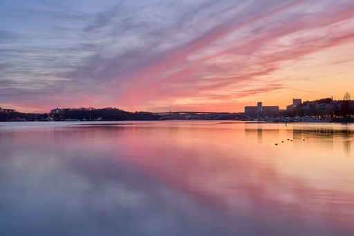 An idyllic scene of Stockholm cityscape on the shore at sunset in Sweden