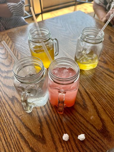 A wooden table with glasses of refreshingly cool lemonade