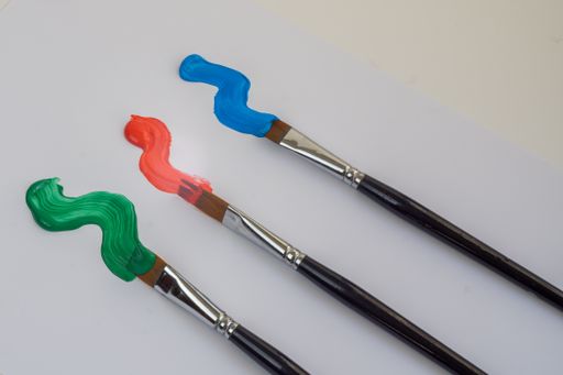 artists brushes with colorful oil paint on a white background, painter tools