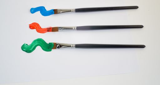 artists brushes with colorful oil paint on a white background, painter tools