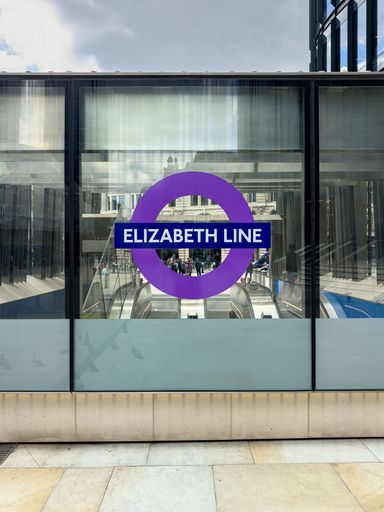 A vertical shot of the words "ELIZABETH LINE" displayed on the window in a train station in the UK