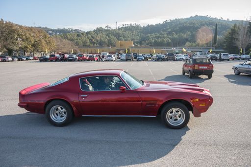 A classic American sports car of second-generation Pontiac Firebird Formula 400 on the street