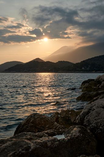 A stunning landscape with the sunset over a mountainous horizon reflected in the lake in Kas, Turkey