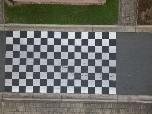 An aerial top view of checkerboard patterns on a raceline