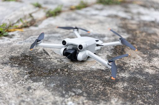A white drone on the ground