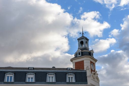 A low angle shot of the clock tower in the Plaza de Espana in Valladolid, Castilla y Leon, Spain