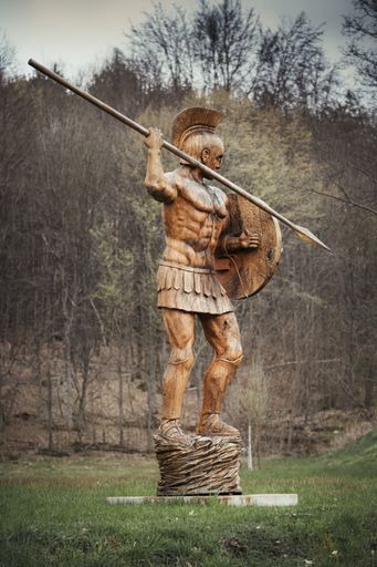 Spartan statue made of wood in front of a building at the university campus in Saarbruecken Germany