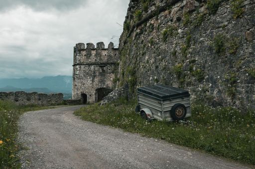 An old castle in Austria with a mountain view over the austrian alps with heavy clouds over it