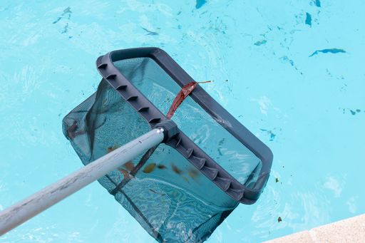 Pool Skimmer cleaning a dirty swimming pool. Pool cleaning concept