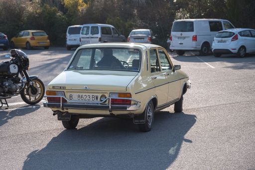 The rear view of a classic light yellow Renault 12 on the street